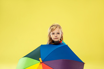 Image showing A full length portrait of a bright fashionable girl in a raincoat