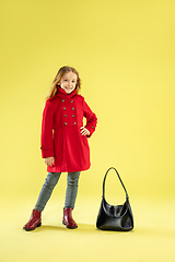 Image showing A full length portrait of a bright fashionable girl in a raincoat