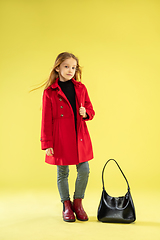 Image showing A full length portrait of a bright fashionable girl in a raincoat