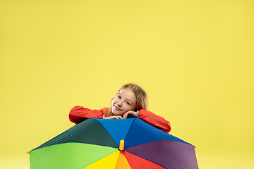 Image showing A full length portrait of a bright fashionable girl in a raincoat