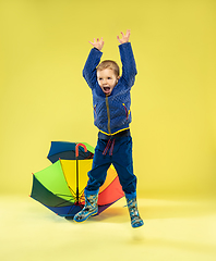 Image showing A full length portrait of a bright fashionable kid in a raincoat