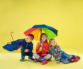 Image showing A full length portrait of a bright fashionable kids in a raincoat