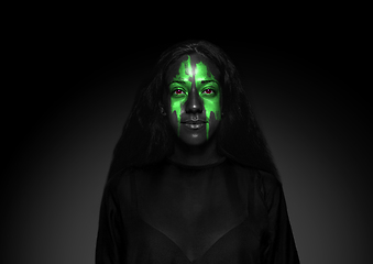 Image showing Close up portrait of young woman isolated on black studio background