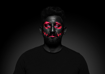 Image showing Close up portrait of young man isolated on black studio background