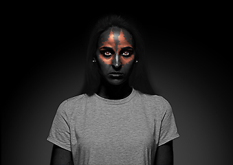 Image showing Close up portrait of young woman isolated on black studio background