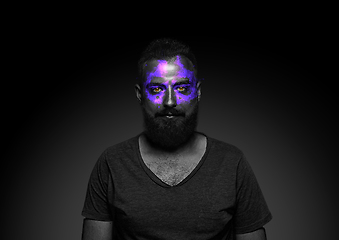 Image showing Close up portrait of young man isolated on black studio background