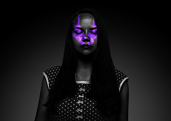 Image showing Close up portrait of young woman isolated on black studio background