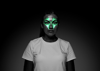 Image showing Close up portrait of young woman isolated on black studio background