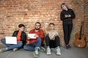 Image showing Group of happy young men and women sharing in social media