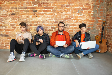 Image showing Group of happy young men and women sharing in social media