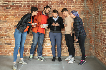 Image showing Group of happy young men and women sharing in social media