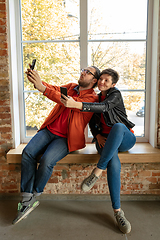 Image showing Happy young man and woman sharing in social media