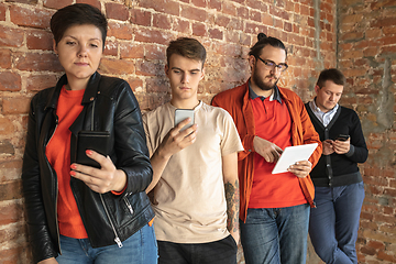 Image showing Group of happy young men and women sharing in social media