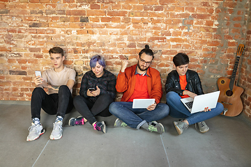 Image showing Group of happy young men and women sharing in social media