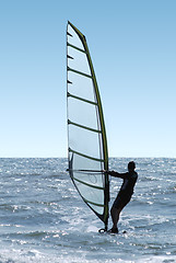 Image showing Silhouette of a windsurfer on a sea 