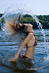 Image showing The young woman bathes in the river