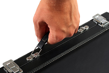 Image showing Hand with a black suitcase. Isolated on white background