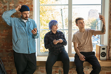 Image showing Group of happy young men and women sharing in social media