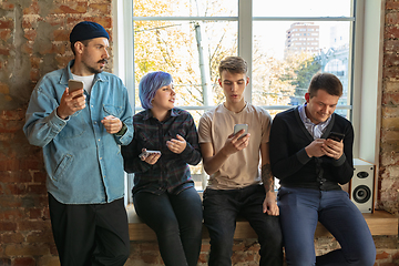 Image showing Group of happy young men and women sharing in social media