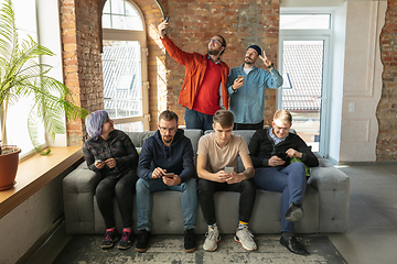 Image showing Group of happy young men and women sharing in social media