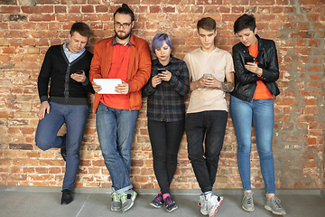 Image showing Group of happy young men and women sharing in social media