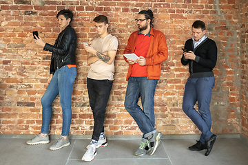 Image showing Group of happy young men and women sharing in social media