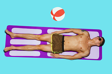 Image showing Top view of young caucasian male model\'s resting on beach resort