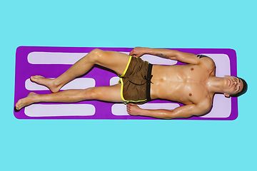 Image showing Top view of young caucasian male model\'s resting on beach resort