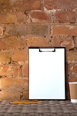 Image showing Mock up blank picture or sheet on the brick wall background