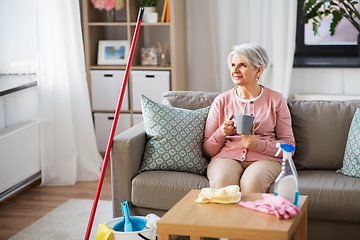 Image showing senior woman drinking coffee after home cleaning