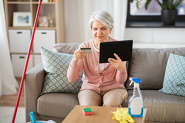 Image showing old woman with tablet pc and credit card at home