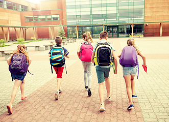 Image showing group of happy elementary school students running