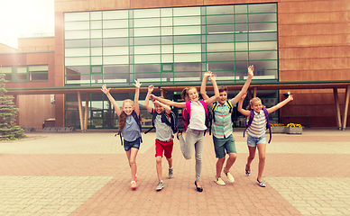 Image showing group of happy elementary school students running