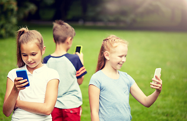 Image showing kids with smartphones playing game in summer park