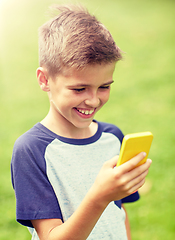 Image showing boy with smartphone playing game in summer park