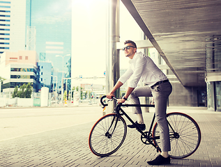 Image showing man with bicycle and headphones on city street