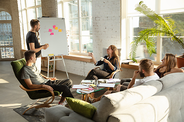 Image showing Group of young caucasian office workers have creative meeting to discuss new ideas