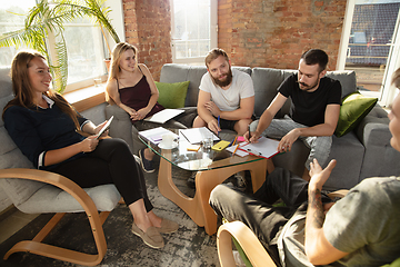 Image showing Group of young caucasian office workers have creative meeting to discuss new ideas