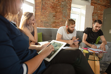 Image showing Group of young caucasian office workers have creative meeting to discuss new ideas