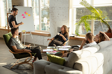 Image showing Group of young caucasian office workers have creative meeting to discuss new ideas