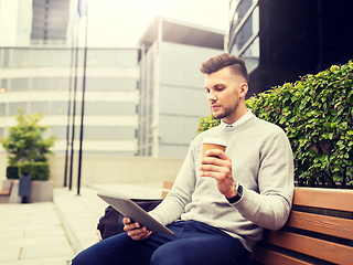 Image showing man with tablet pc and coffee on city street bench