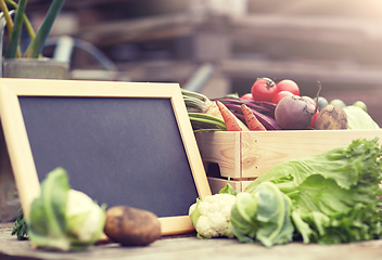 Image showing close up of vegetables with chalkboard on farm