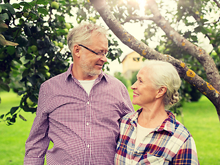 Image showing happy senior couple hugging at summer garden