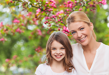 Image showing happy mother and daughter over garden