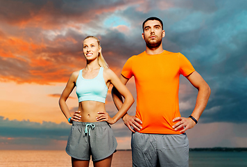 Image showing happy couple exercising over sea