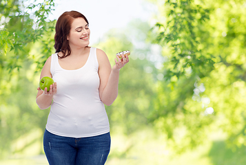 Image showing plus size woman choosing between apple and donut