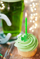 Image showing green cupcake with candle, beer and horseshoe