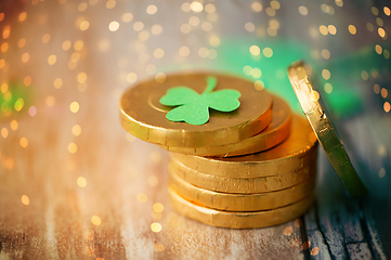 Image showing gold coins with shamrock on wooden table
