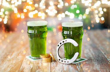 Image showing glasses of green beer, horseshoe and gold coins