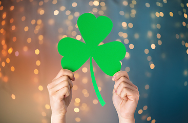 Image showing hands holding green paper shamrock